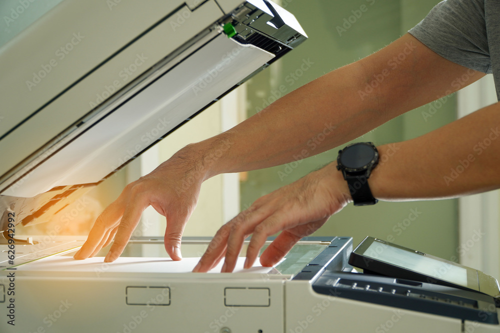 Photocopier printer,Men press the button of the copier. Man copying