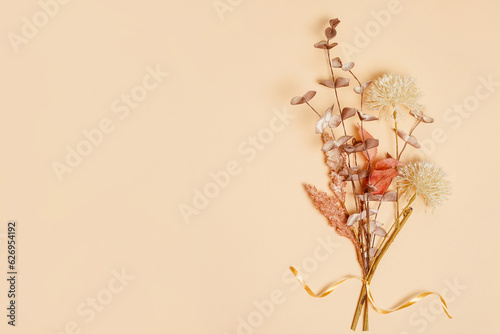 Dry flowers bouquet on beige background with copy space.Autumn vibes