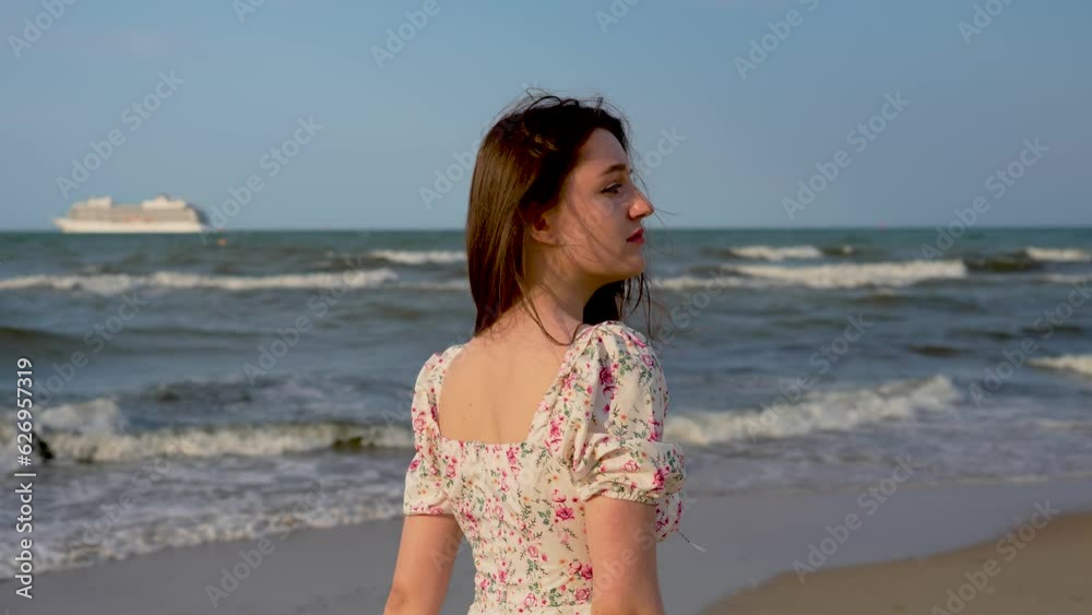 Woman with brown eyes walking at sunset. Beautiful young female with black hair feeling pleasure of vacations at sea beach. Relax leisure activity, active lifestyle, cheerful confident attractive girl Woman with brown eyes walking at sunset. Beautiful young female with black hair feeling pleasure of vacations at sea beach. Relax leisure activity, active lifestyle, cheerful confident attractive girl