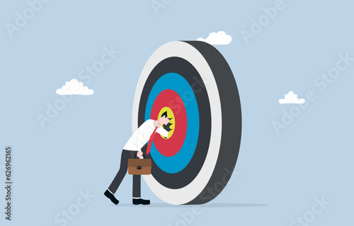 Deep understanding of business target, comprehensive and detailed knowledge of the business goal, thorough market research concept, Businessman ducking head into target.
