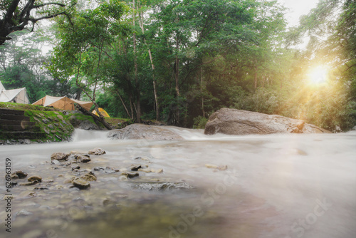 Campground Outdoor tent camping picnic group waterfall zone, equipment, natural camping area landscape background, with trees and green grass, summer trip relax and holiday Adventure Travel concept