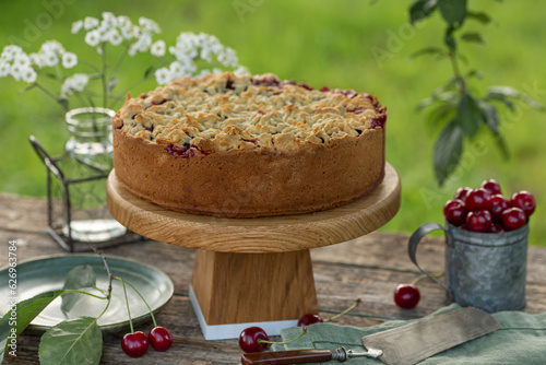 sour cherry crumble cake on  wooden table photo