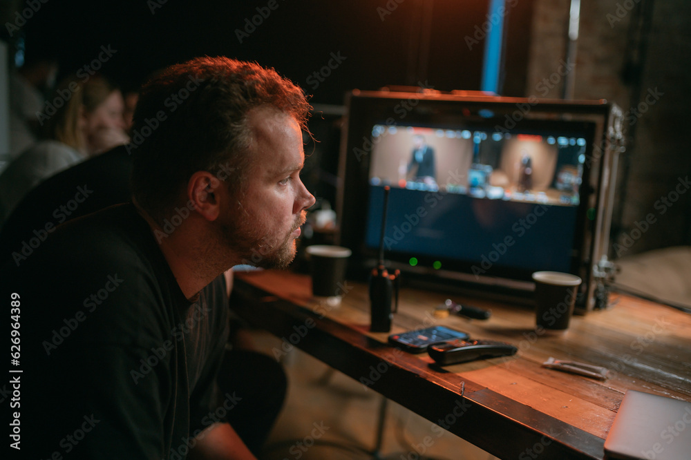 Director at work on the set. The director works with a group or with a playback while filming a movie