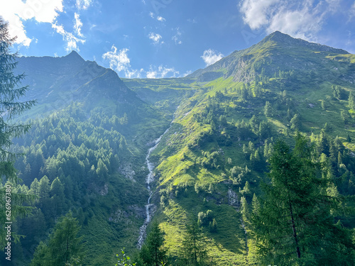 Summer landscape with mountains forests and cloudy sky in Alpes. Austria. Tranquility. Beauty and tranquility in farming. Natural and healthy living in a village. 