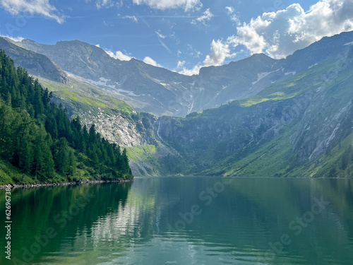 Summer landscape with mountains forests and cloudy sky in Alpes. Austria. Tranquility. Beauty and tranquility in farming. Natural and healthy living in a village. 