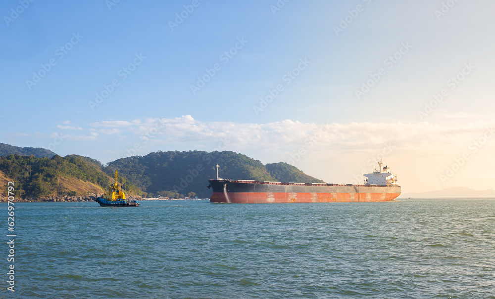 Tugboat waiting for a petrochemical vessel entering the port of Santos