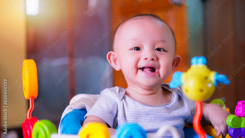 Obraz premium Close-up portrait of face cute Asian newborn baby boy with happy smile and funny laughing