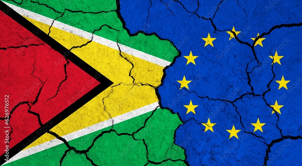 Flags of Guyana and European Union on cracked surface - politics, relationship concept