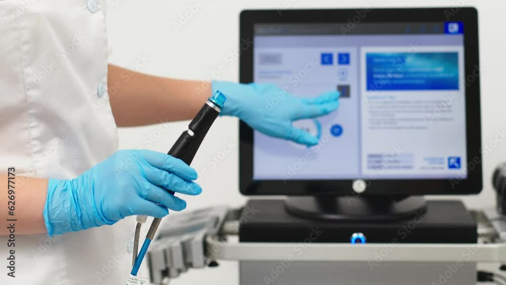 Facial skin care machine in spa clinic for anti-aging or acne treatment. The concept of aesthetic medicine, beauty tools, latest technologies in beauty industry. Facial skin care machine in spa clinic for anti-aging or acne treatment. The concept of aesthetic medicine, beauty tools, latest technologies in beauty industry.
