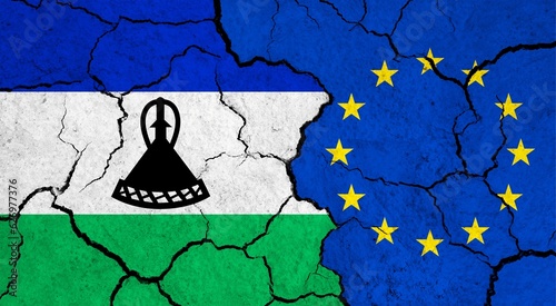 Flags of Lesotho and European Union on cracked surface - politics, relationship concept