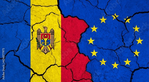 Flags of Moldova and European Union on cracked surface - politics, relationship concept
