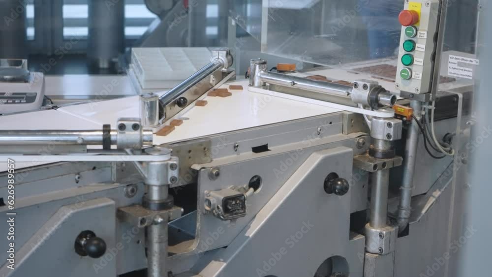 Chocolate factory, toppings on the conveyor of a confectionery factory, slow motion Chocolate factory, toppings on the conveyor of a confectionery factory, slow motion