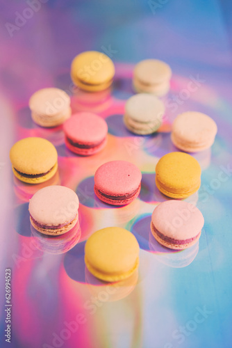 French cake macaron. Set of cute sweets on colorful rainbow background. almond cookies, pastel colors, top view