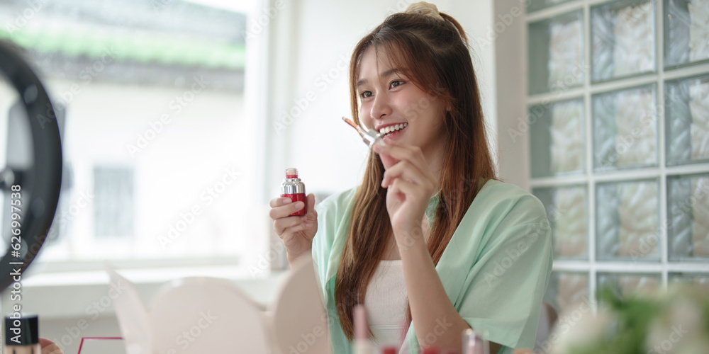 Female beauty blogger Influencer filming cosmetics makeup or comparing review on live stream.. Female beauty blogger Influencer filming cosmetics makeup or comparing review on live stream..