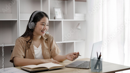 Young asian student watching lesson online and studying from home. online education concept