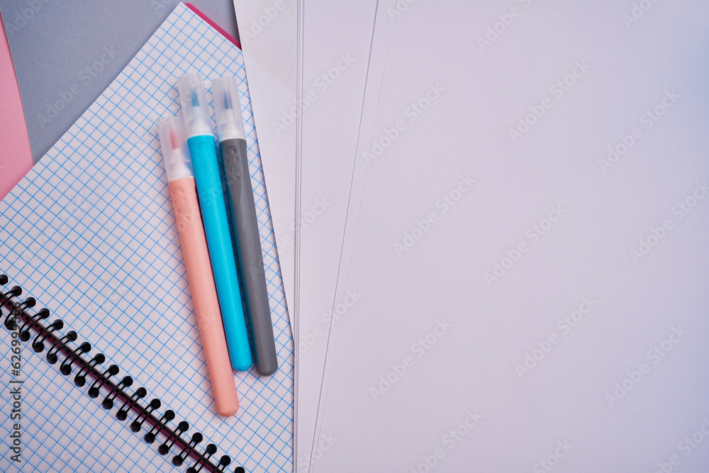 Top view of blank notepads, pen and markers. Mockup. The concept of office and school supplies, school year Top view of blank notepads, pen and markers. Mockup. The concept of office and school supplies, school year