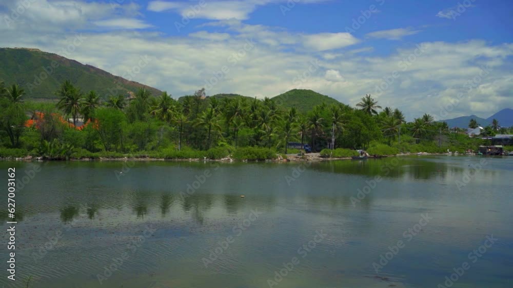 Song Nac reservoir on the outskirts of Nha Trang city in Vietnam. Sunny summer day, panoramic video shooting. Song Nac reservoir on the outskirts of Nha Trang city in Vietnam. Sunny summer day, panoramic video shooting.