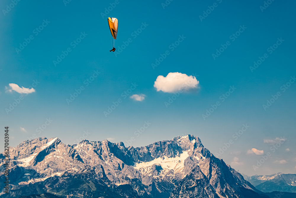 Alpine summer view with a paraglider at Mount Wank, Garmisch-Partenkirchen, Bavaria, Germany Alpine summer view with a paraglider at Mount Wank, Garmisch-Partenkirchen, Bavaria, Germany