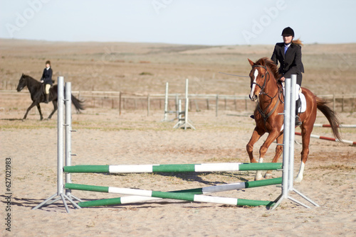 Sport, training and equestrian with woman on horse for show, competition and performance. Fitness, derby and health with female jockey on animal in countryside for obstacle, horseback and rider event