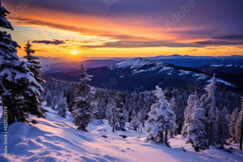A winter landscape at sunrise. a snow-covered mountain range with a colorful sunrise in the background
