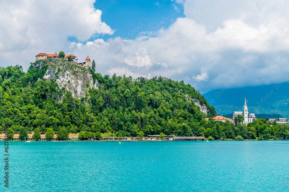 A view towards the castle and church on the the shore of Lake Bled in Bled, Slovenia in summertime A view towards the castle and church on the the shore of Lake Bled in Bled, Slovenia in summertime