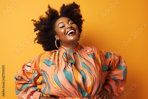 plus sized smiling happy black woman with afro wearing bright clothes on a pastel background, studio shot
