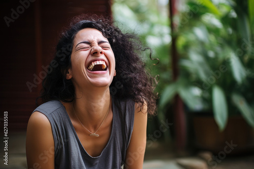 A person participating in a laughter yoga session to lift their spirits.
