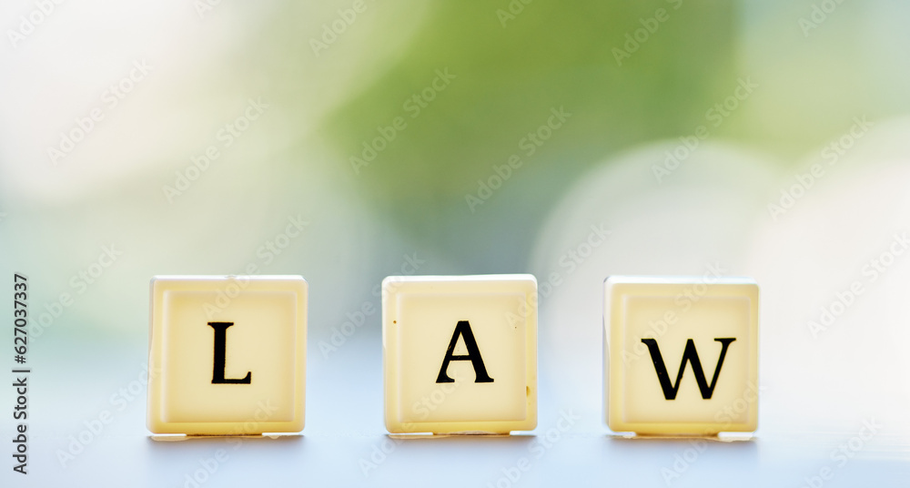 Law letter, and table with block cubes in outdoor blur with mock up space for justice or attorney. Legal, alphabet and questions for support or services in brokeh background with regulation for help. Law letter, and table with block cubes in outdoor blur with mock up space for justice or attorney. Legal, alphabet and questions for support or services in brokeh background with regulation for help.