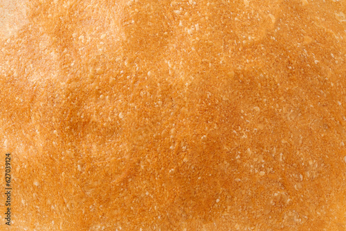 Baked bread crust, close-up surface, uniform texture background © elenvd