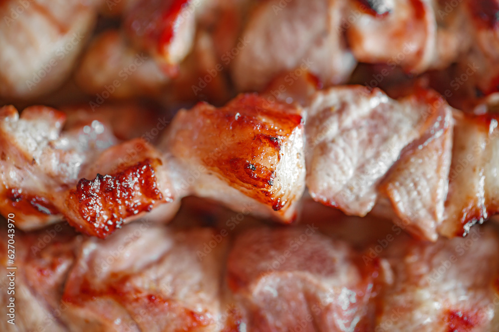 Grilled meat cooked fried in chunks, close-up, selective focus