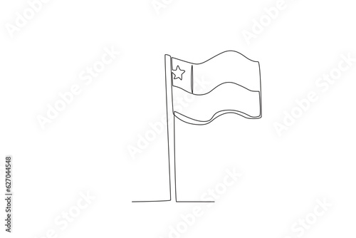 A Chilean flag flutters on a pole. Fiestas patrias chile