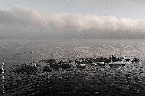 Rocks by Lake Mjosa a misty winter day. photo
