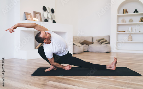 Flexible woman practicing yoga in Extended Side Angle pose