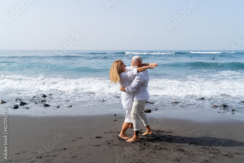 lifestyle of caucasian senior couple dance on beach, happy in love romantic and relax time, tourism of elderly family pleople, leisure and activity travel after retirement in vacations and summer