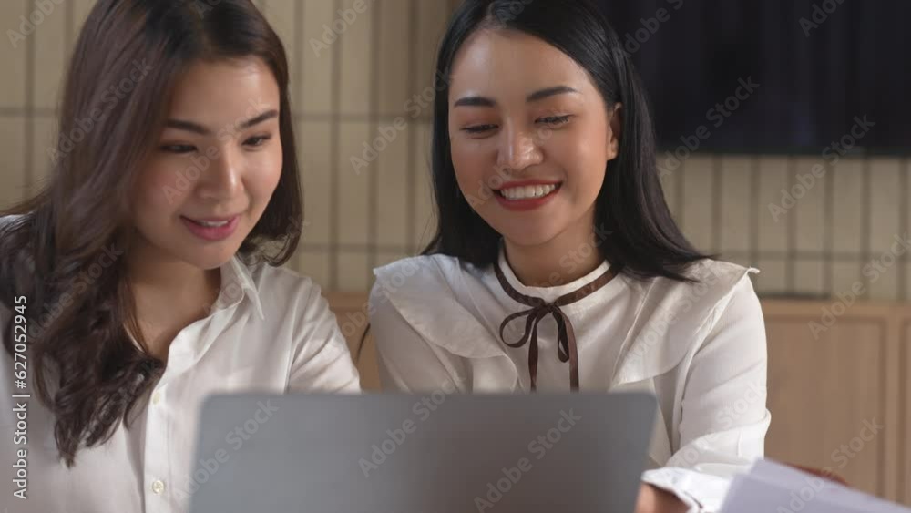 Asian office employee supervising Mentor training intern at office Asian office employee supervising Mentor training intern at office