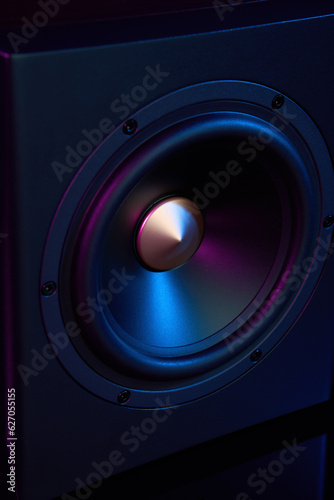 Multimedia acoustic sound speaker with neon lighting. Sound audio system on dark background.