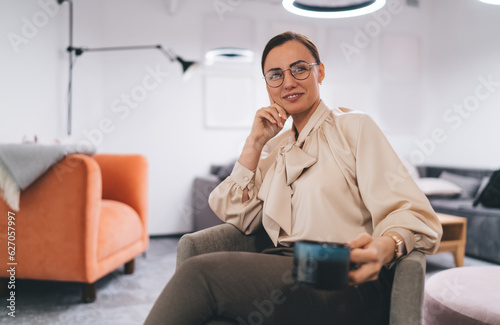 Happy woman sitting with cup of coffee © BullRun