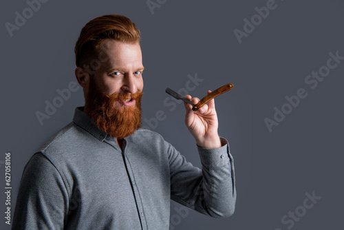 smiling man shave with barbershop blade isolated on grey background. man shave with blade