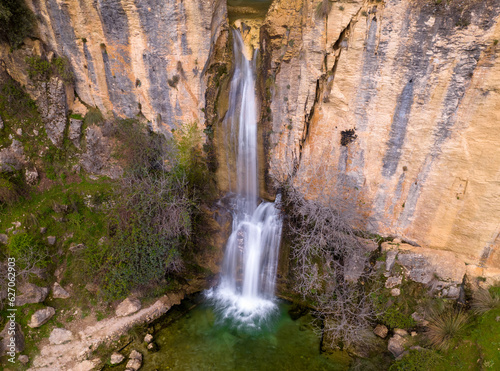 Waterfall and colorful water at sunrise. Photo long exposure silky water effect. Aerial photography. Castril. Andalusia. Spain.