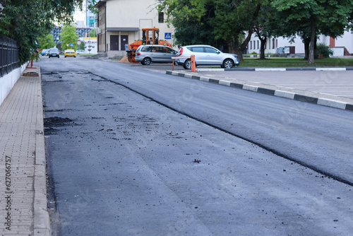 Large layer of fresh hot asphalt. Asphalt layer. Road construction. Construction of a new road.