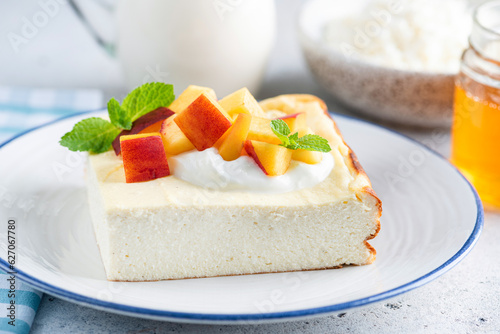 Cottage cheese casserole Zapekanka with peach, sour cream and honey. Sweet breakfast cheese cake