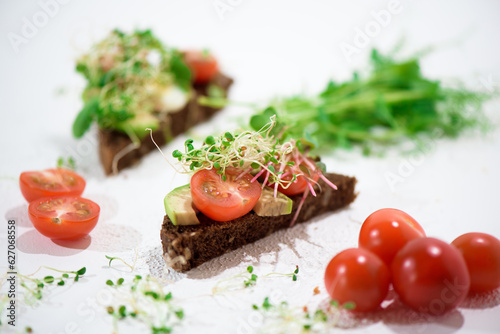 Toasts with microgreens. Hand holds a healthy toast. Healthy food concept. Super food.