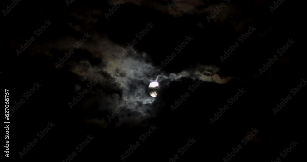 Across the night sky, moon moves.