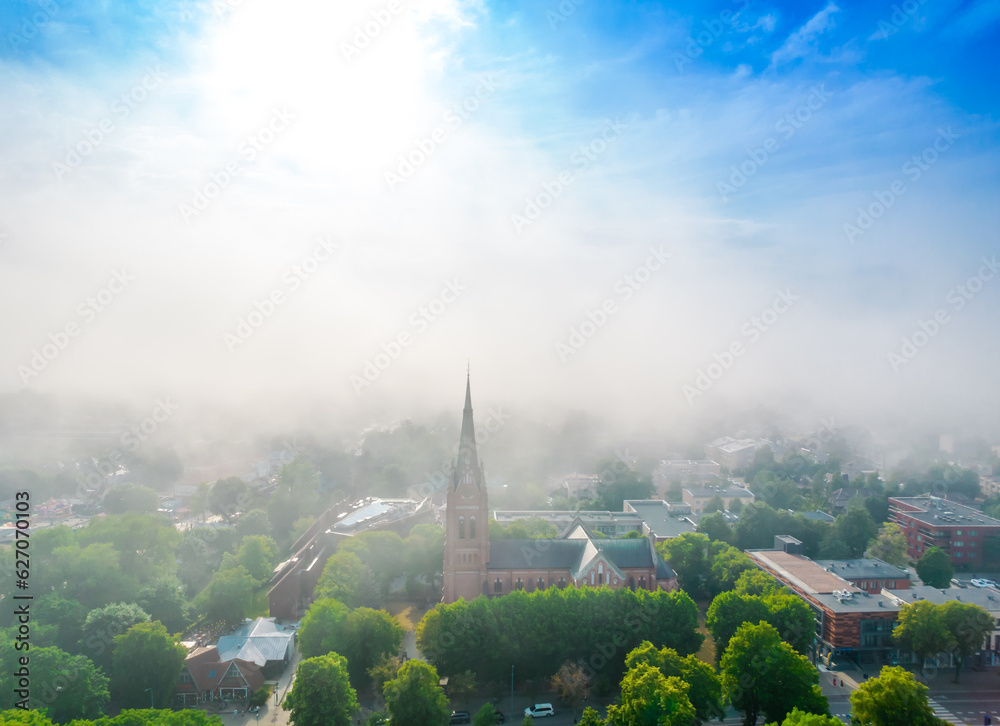 Church of Saint Marie in haze in Palanga, Lithuania. Aerial view on a foggy day. Low clouds over the city
