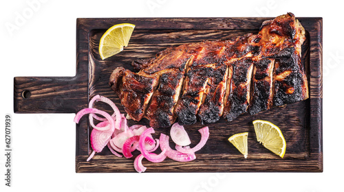 Grilled caramelized pork ribs on wooden tray isolated above