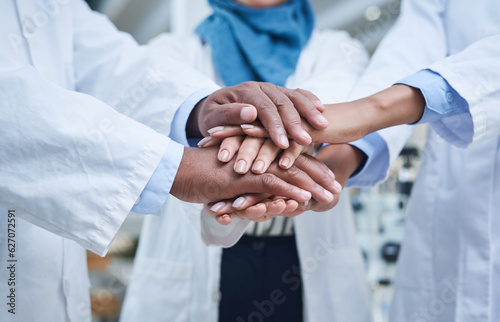 Closeup, hands and group in a hospital, healthcare or scientists with support, motivation or solidarity. Zoom, coworkers or medical professional with teamwork, collaboration or team building in a lab