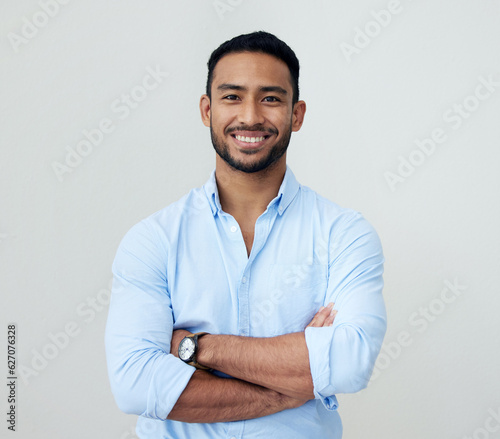 Economist, portrait and business man with arms crossed in studio isolated on a white background. Face, confidence and happy Asian male professional, entrepreneur or analyst from Singapore with mockup