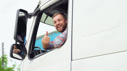 Truck driver sitting in his truck showing thumbs up. Trucker occupation. Transportation services