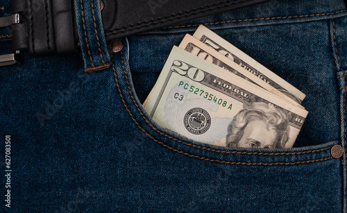 American dollars in the pocket of blue jeans. 
