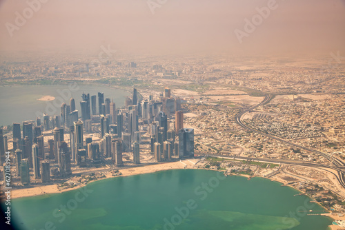 Doha, Qatar - September 17, 2018: Aerial view of city skyline from a flying airplane over the Qatar capital